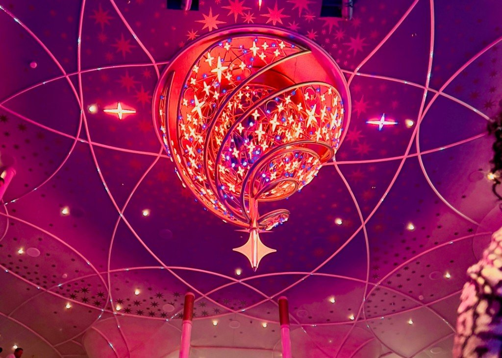 Looking up at the Grand Hall chandelier on Disney Wish